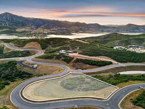 Aerial view of property and surrounding area with a water and mountain view