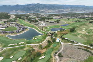 View of property location with a water and mountain view and a golf course