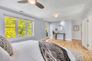Bedroom with light wood-style flooring, access to outside, and ceiling fan