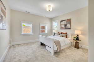 Carpeted bedroom featuring baseboards