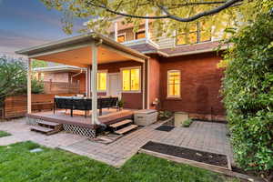 Rear view of house with an outdoor hangout area, a patio area, a wooden deck, and roof with shingles