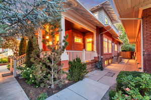 Property entrance featuring a porch and brick siding