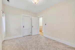 Unfurnished bedroom with carpet flooring