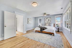 Bedroom featuring light wood-style floors and a ceiling fan