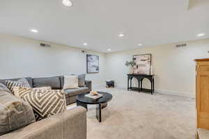 Living area featuring carpet flooring and recessed lighting