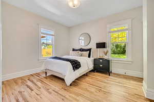 Bedroom featuring baseboards and wood finished floors