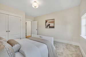 Bedroom featuring carpet and a closet