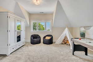 Rec room with light carpet and vaulted ceiling