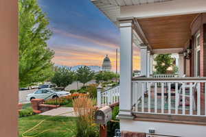 Balcony at dusk featuring a porch