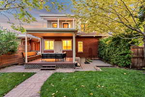 Rear view of house with a deck, an outdoor living space, and a patio
