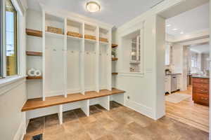 Mudroom featuring ornamental molding and recessed lighting