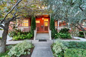 View of exterior entry with a porch and brick siding