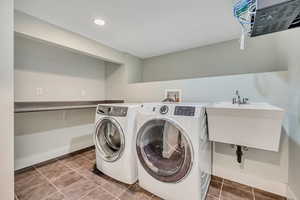 Laundry room featuring washer and dryer, tile patterned flooring, and recessed lighting