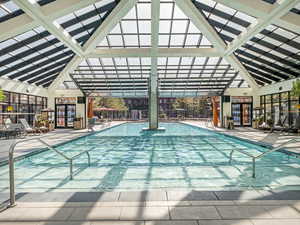 Indoor community pool featuring a patio area
