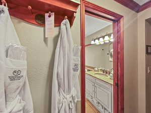 Half bath featuring a textured wall, vanity, and light tile patterned floors