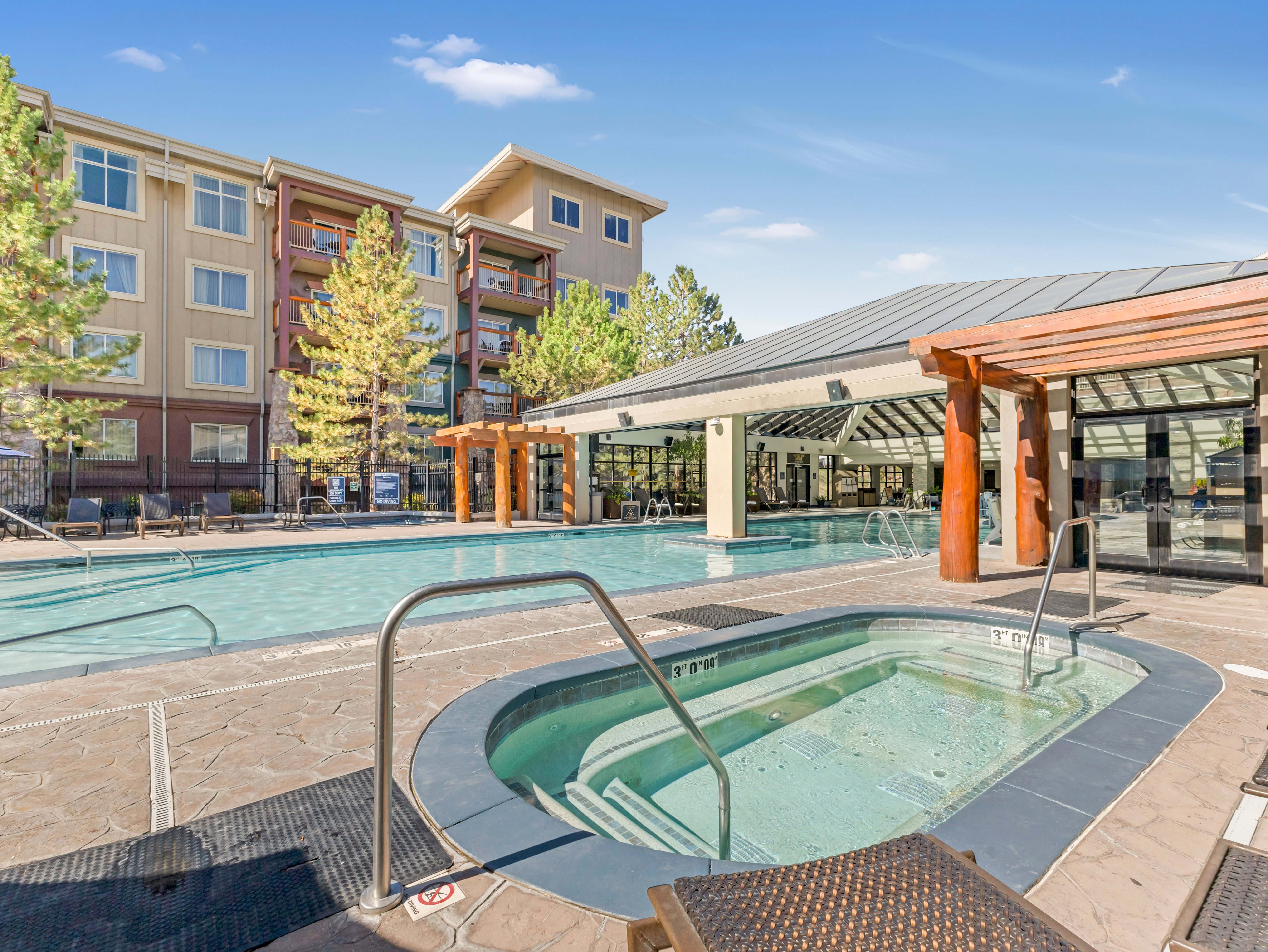 Community pool featuring a community hot tub