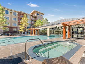 Community pool featuring a community hot tub