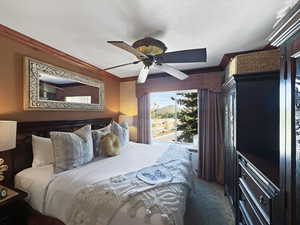 Bedroom with crown molding, a ceiling fan, a textured ceiling, and access to exterior