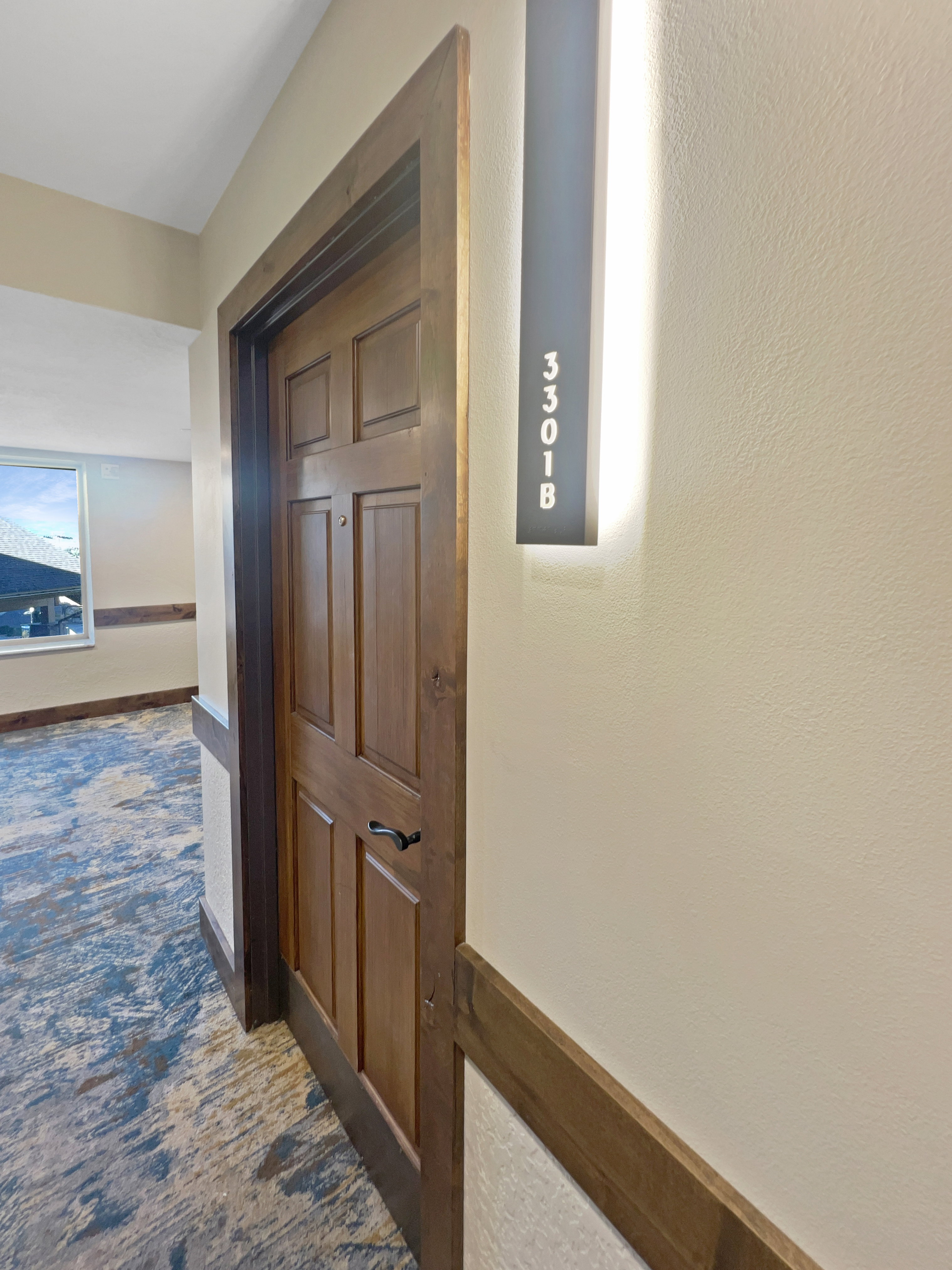 Hall featuring dark carpet