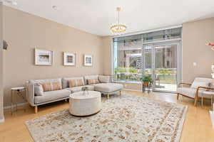 Living area with wood finished floors and a chandelier