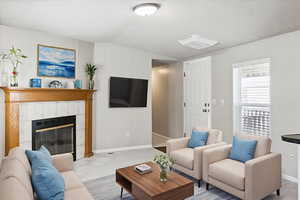 Tiled living room with a fireplace and a decorative wall