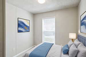 Bedroom featuring a textured ceiling