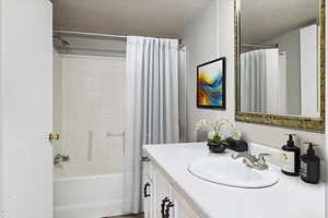 Full bath with vanity and shower / bathtub combination with curtain