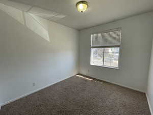 Carpeted 3rd bedroom featuring carpet and baseboards