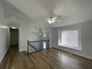 Unfurnished room featuring wood finished floors and a ceiling fan