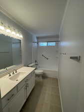 Bathroom featuring updated vanity, tile patterned floors, and bathtub / shower combination