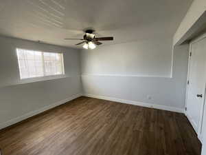 5th bedroom featuring dark wood-style flooring, closet and ceiling fan