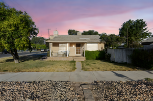 Single story home featuring a porch and a chimney