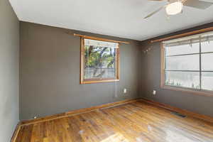 Empty room featuring hardwood / wood-style floors and a ceiling fan