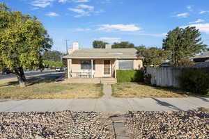 Bungalow-style home with a porch and a chimney