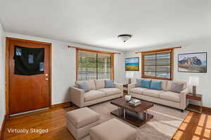 Living area with wood finished floors and baseboards