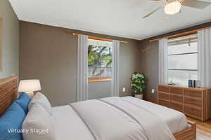 Bedroom with light wood-type flooring and a ceiling fan