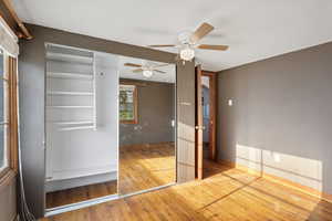 Unfurnished bedroom featuring hardwood / wood-style flooring and ceiling fan
