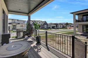 Wooden deck with a residential view and grilling area