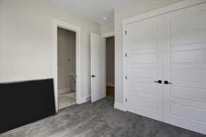 Unfurnished bedroom featuring carpet and a closet