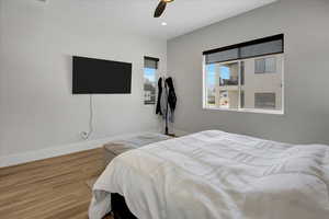 Bedroom featuring wood finished floors, a ceiling fan, and recessed lighting