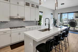 Kitchen with light wood-style flooring, plenty of natural light, light countertops, and recessed lighting