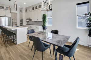Dining area featuring light wood-type flooring and recessed lighting