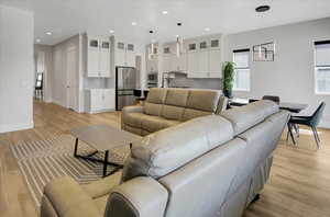 Living room featuring light wood-style floors and recessed lighting