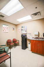 Office featuring a paneled ceiling and a sink
