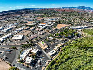 Aerial view of property's location featuring a mountainous background