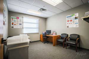 Office space featuring a drop ceiling and carpet