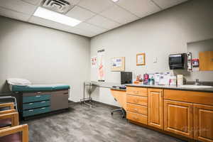 Office area with a drop ceiling and a sink