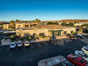 View of property with uncovered parking and a mountain view