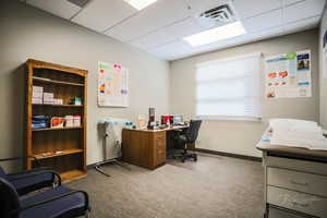 Office featuring carpet floors and a drop ceiling