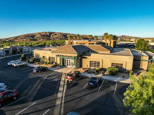 View of property with a mountain view and uncovered parking